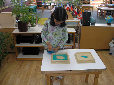 girl pouring water Montessori practical life curriculum activity