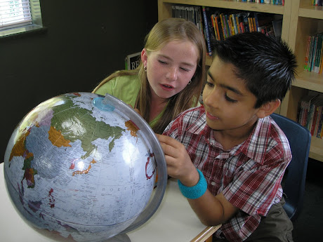 boy and girl with globe Second Plane of Development Ages 6-12 NAMC Montessori Philosophy