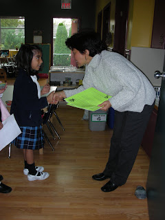 girl shaking hands with NAMC montessori teacher the goals of montessori education