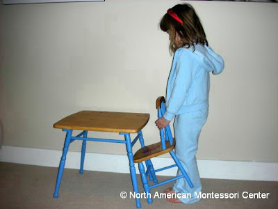 importance NAMC montessori practical life activities classroom girl pushing in chair