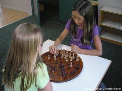 winter enrichment activities for NAMC montessori school girls playing chess