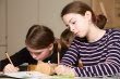 christmas activities NAMC montessori classroom wrapping paper girls writing