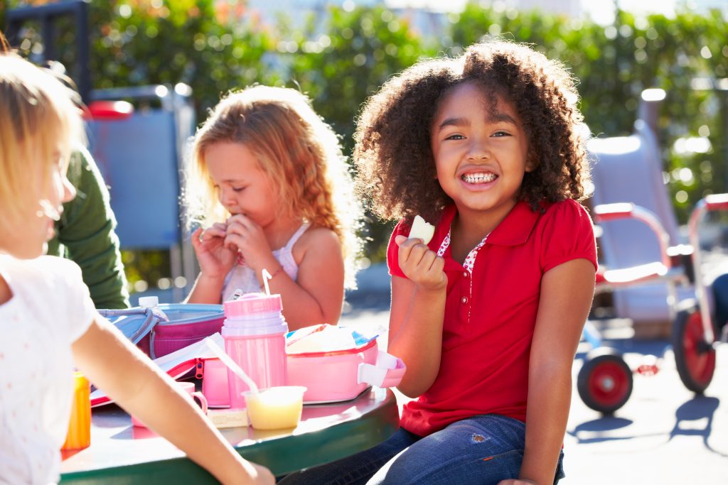students eating lunch outside at school