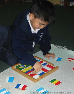 NAMC montessori education nurturing concentration in child respect observation modeling behavior using flag puzzle