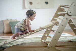 Toddler climbing up Pickler Triangle