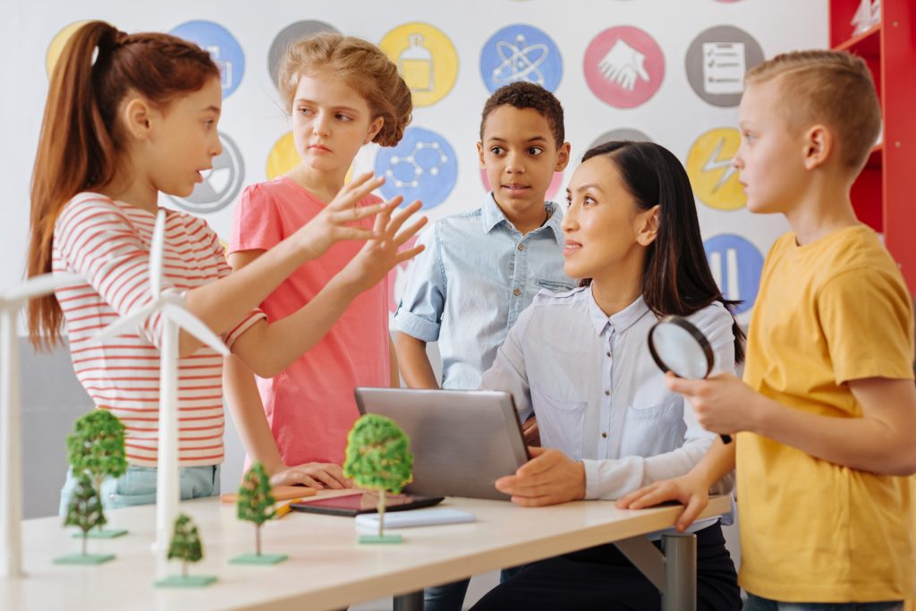 Montessori teacher and students discussing the world