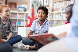 Elementary students listening to story in Montessori classroom