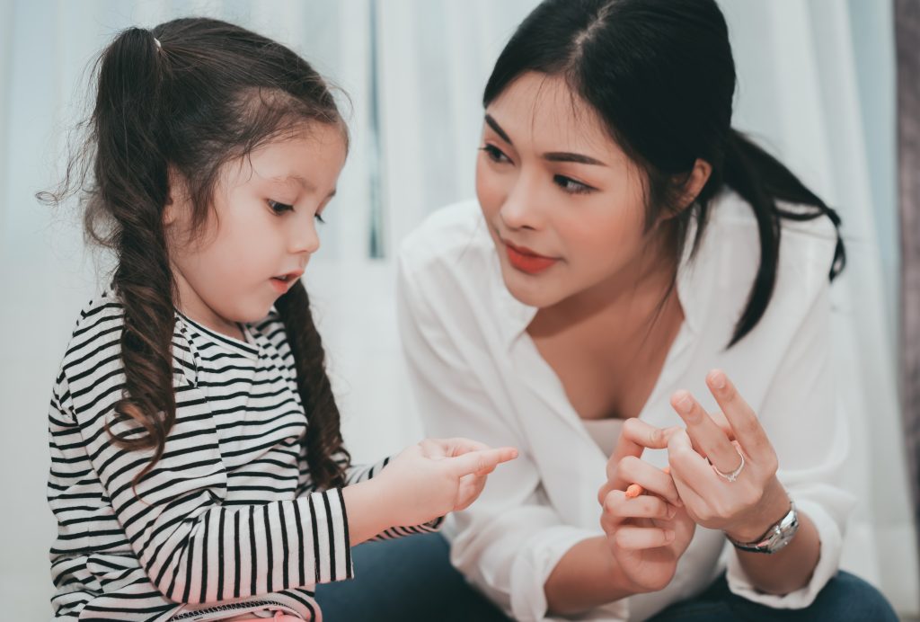 Parent and child counting on their fingers