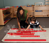 NAMC montessori teacher and child work with red rod sensorial material follow the child help autism