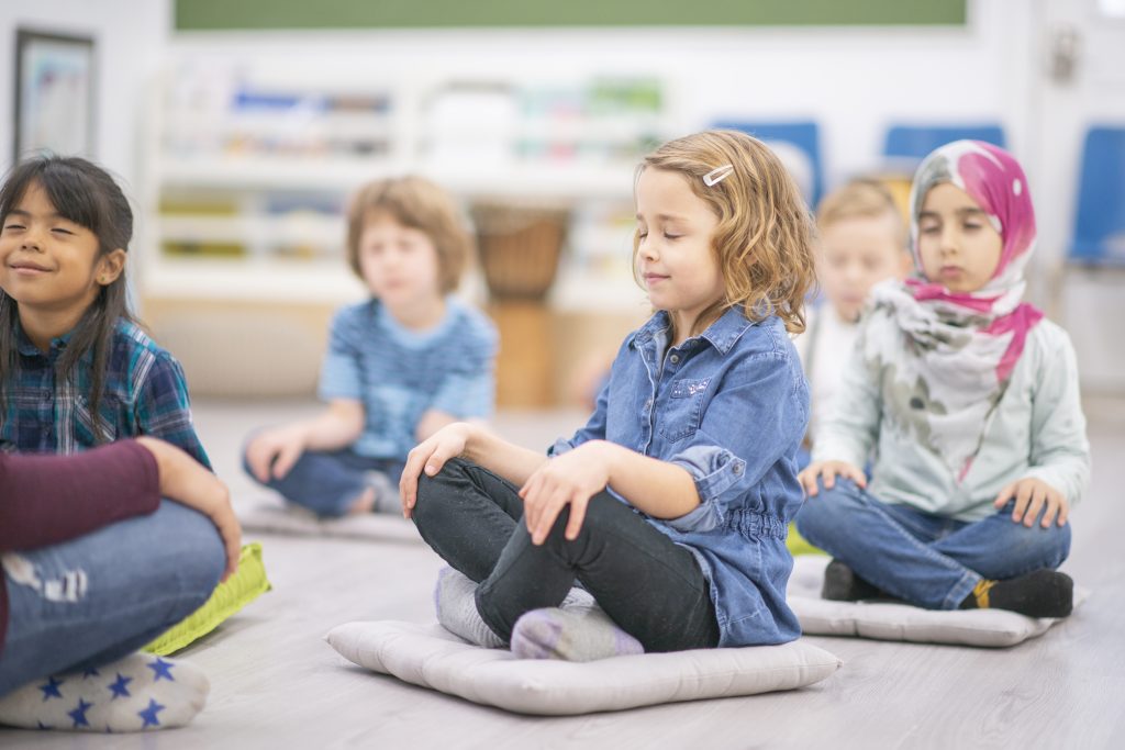 Montessori students practicing mindfulness with Silence Game
