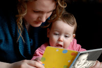 NAMC montessori recommended community reading list infant and toddler montessori teacher reading with toddler