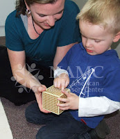 NAMC montessori teacher and child play with thousand block why we believe in the montessori method