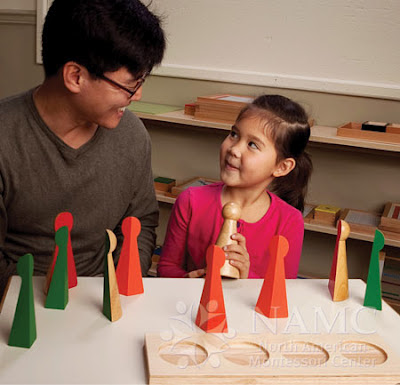 NAMC montessori teacher child working with fraction skittles adding materials to montessori environment