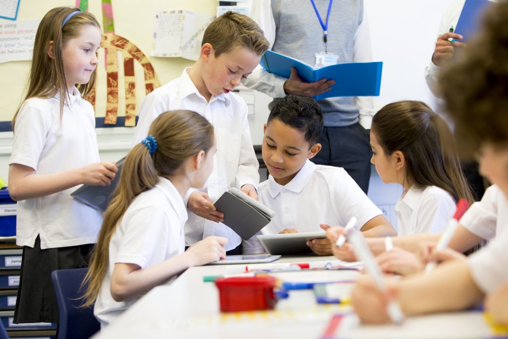 Group of elementary students working on a project together