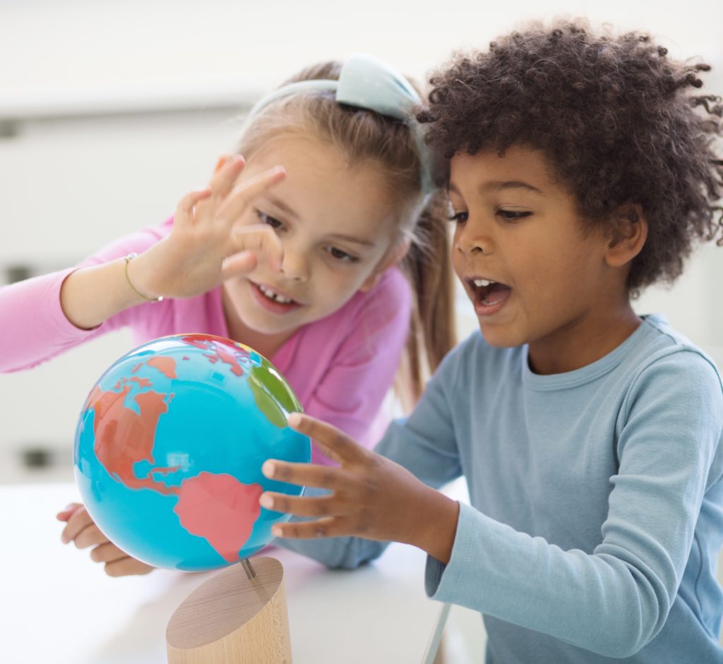 Two Montessori students examining Colored Globe