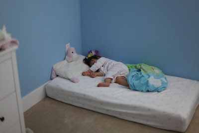Montessori toddler bedroom. Toddler in bed on floor