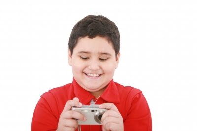 NAMC using a digital camera in the montessori classroom boy taking photo
