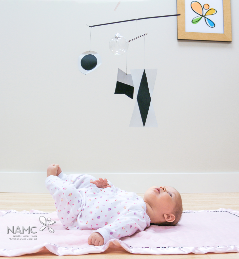 Infant looking at Montessori Munari mobile
