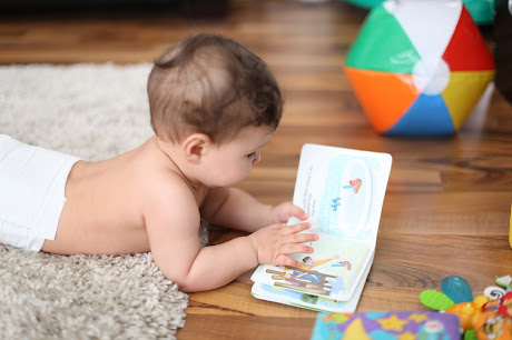 NAMC montessori infant toddler environment preparing for movement crawling for a book