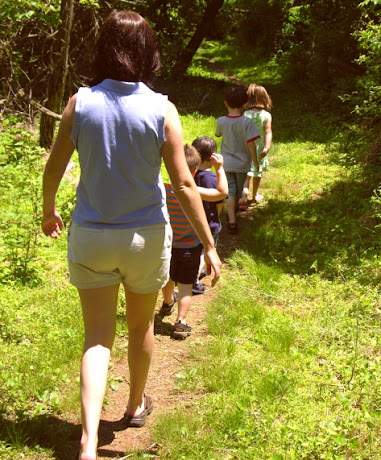 NAMC encouraging quiet in the montessori environment teacher walking outside with students