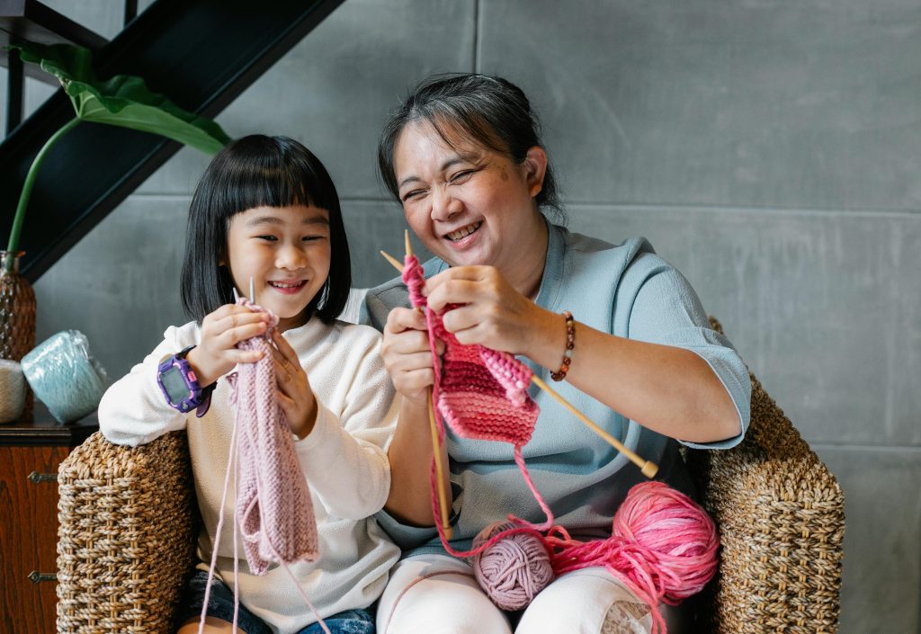 adult and child knitting together