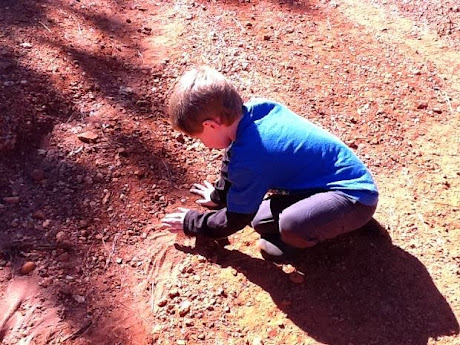 namc montessori sensorial work with soil exploring earth boy playing with dirt