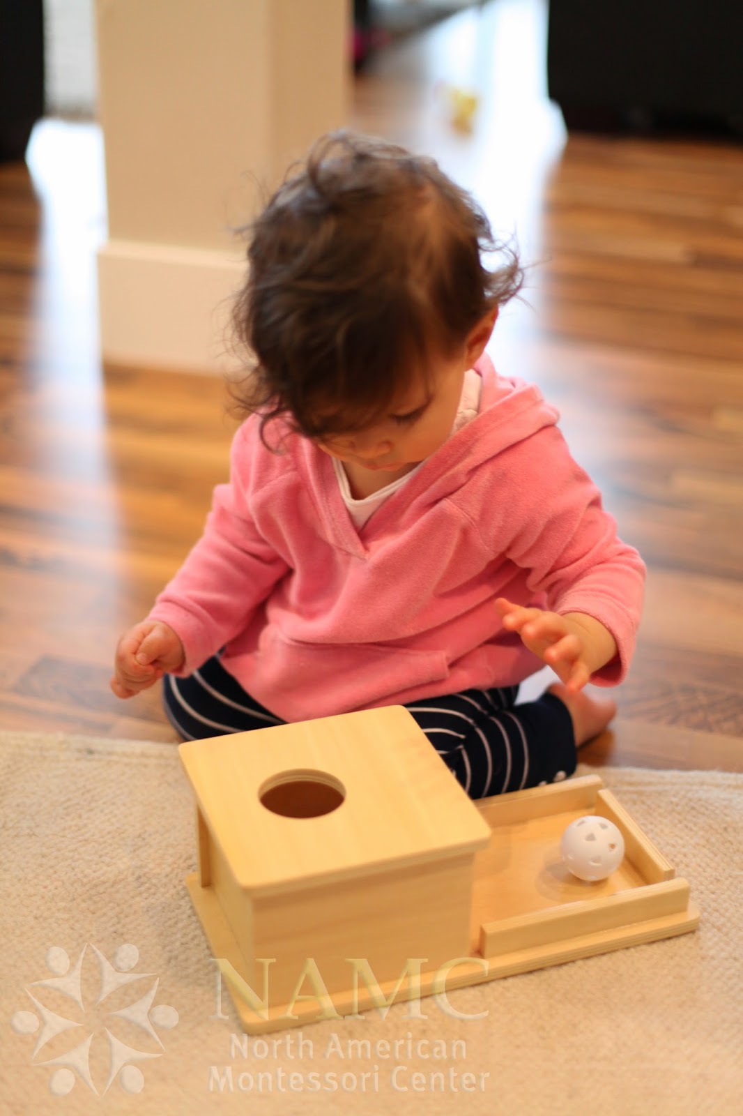 NAMC Montessori developing object permanence girl with box and ball