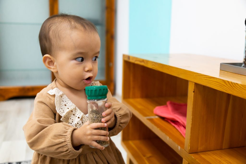 toddler excited to experience a new smell with the smell bottles