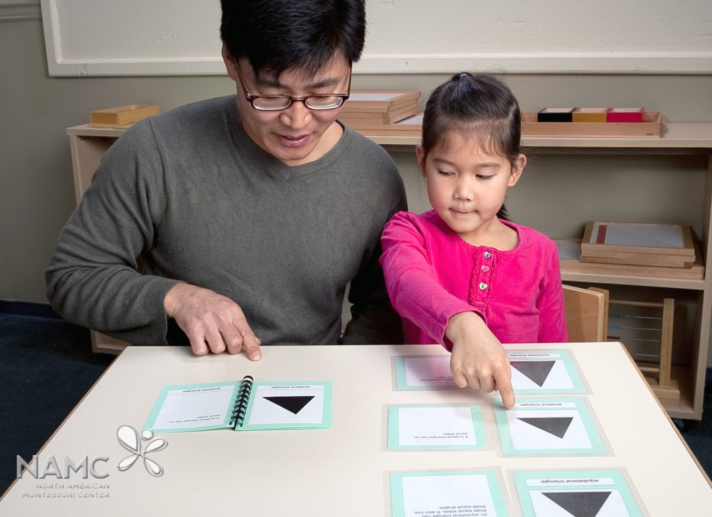 Montessori teacher and elementary student working with geometry nomenclature material