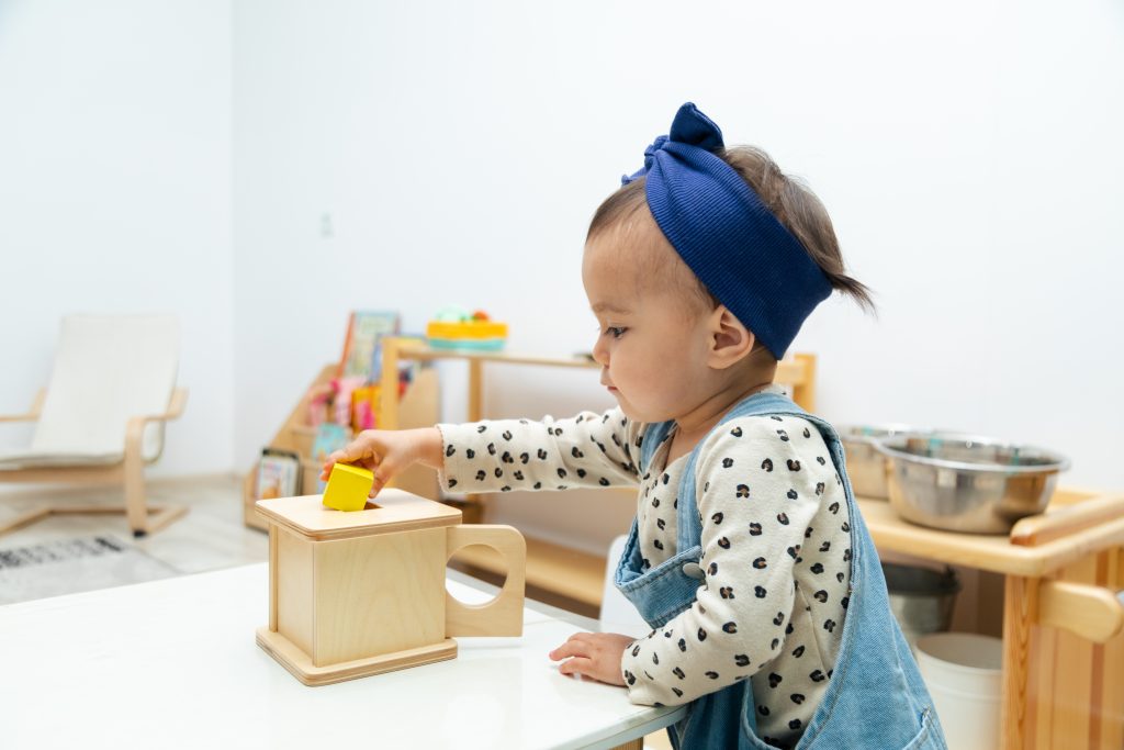 Toddler working with Montessori imbucare box