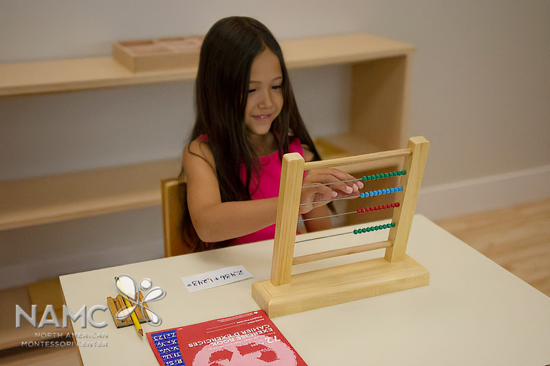 Montessori elementary student solving equation on bead frame