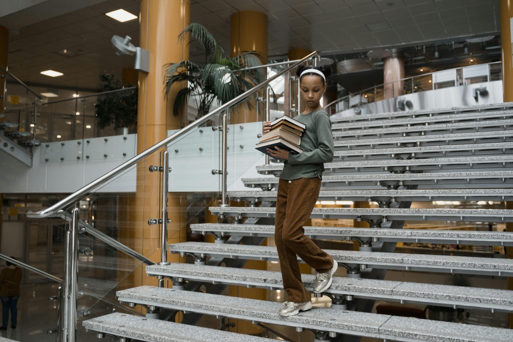 Elementary student walking downstairs at library