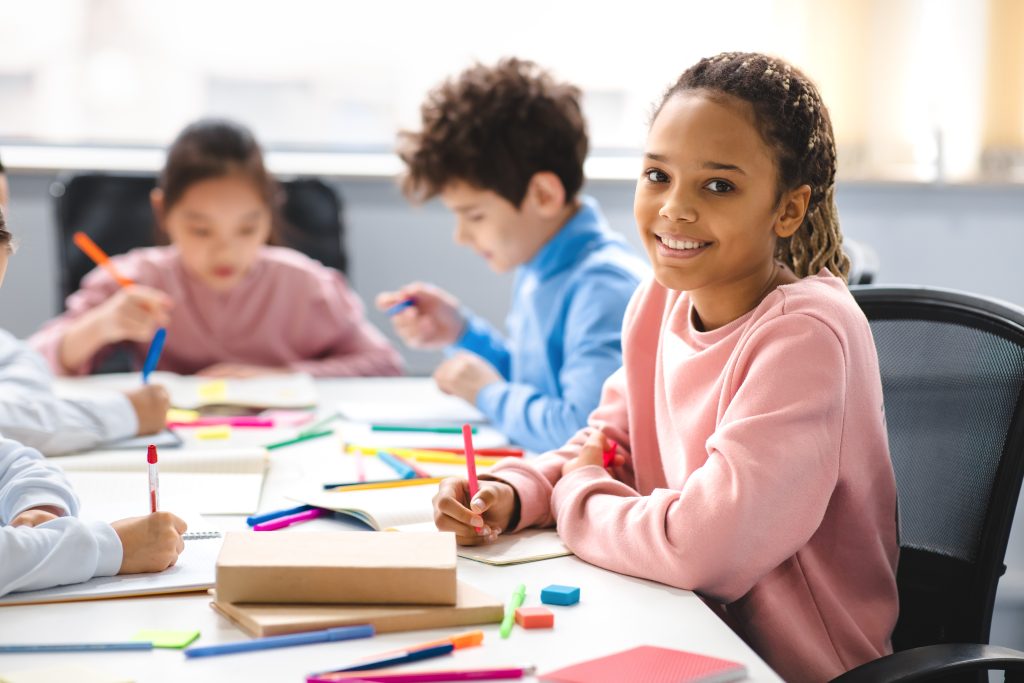 Students working at desk together in classroom