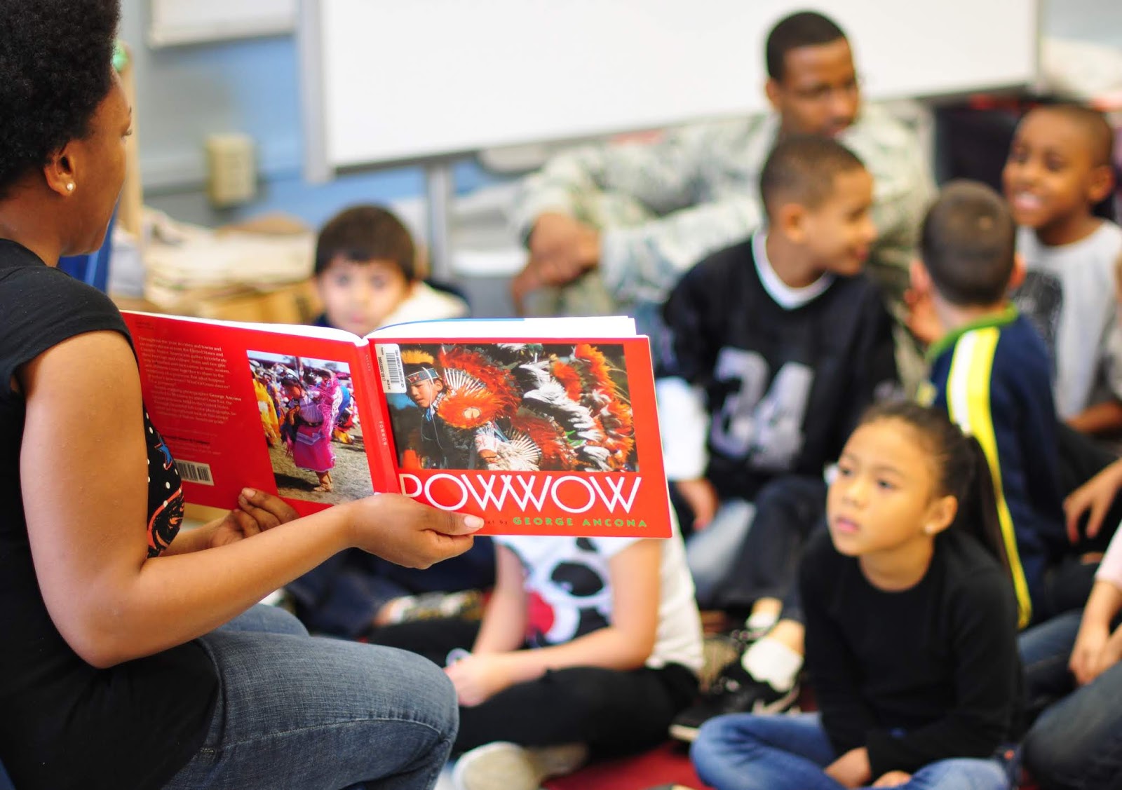 NAMC Presenting Native American Heritage Month in the Montessori Environment teacher reading to children.