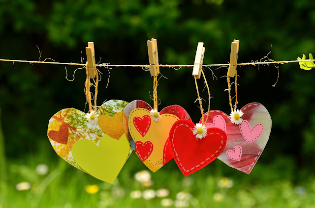 NAMC International Day for Tolerance Peace in the Montessori Environment hearts on clothesline.