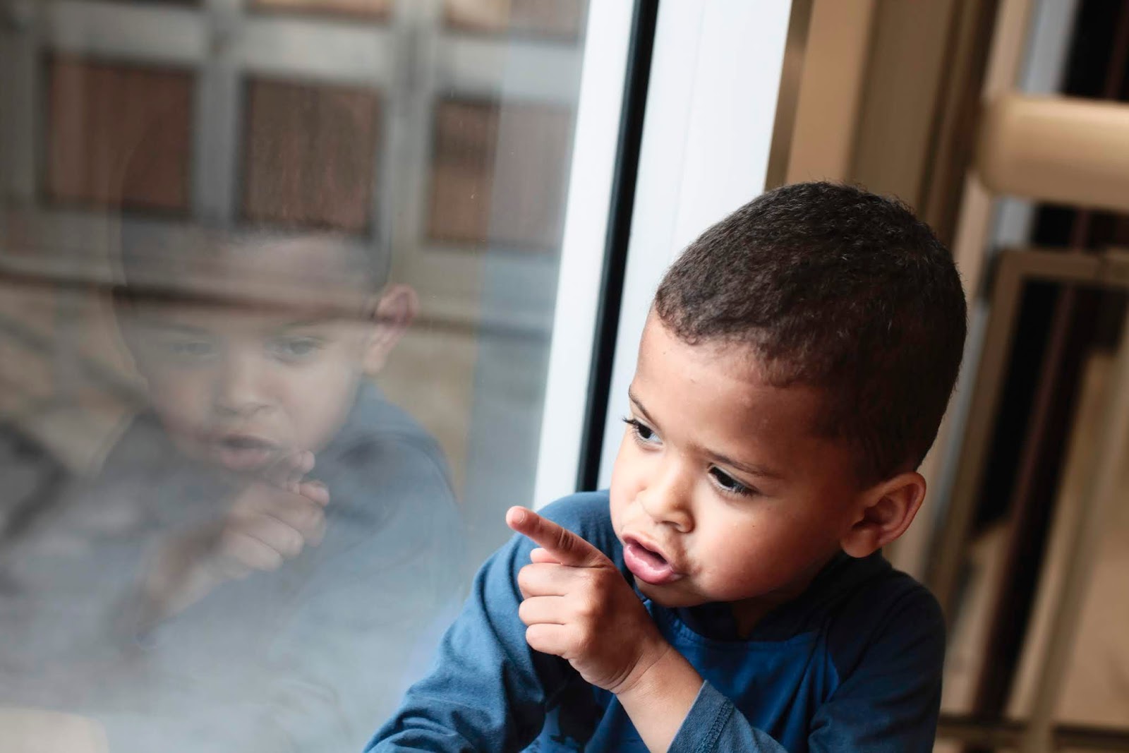 montessori activities at home. Child looking at clouds through window.