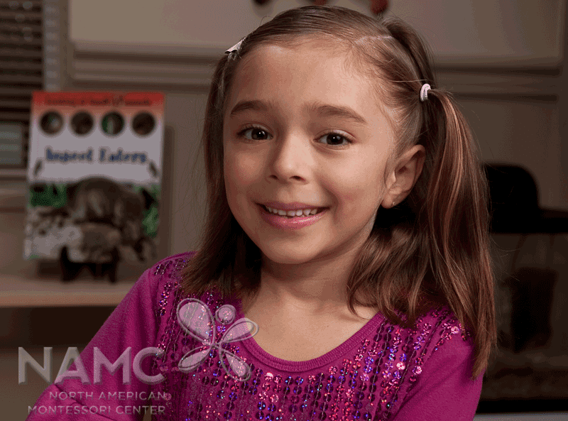 namc montessori abstract materials to concrete: binomial cube. girl smiling