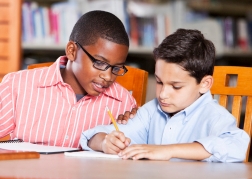 NAMC Montessori circle of inclusion developing organized work. boys writing in journal