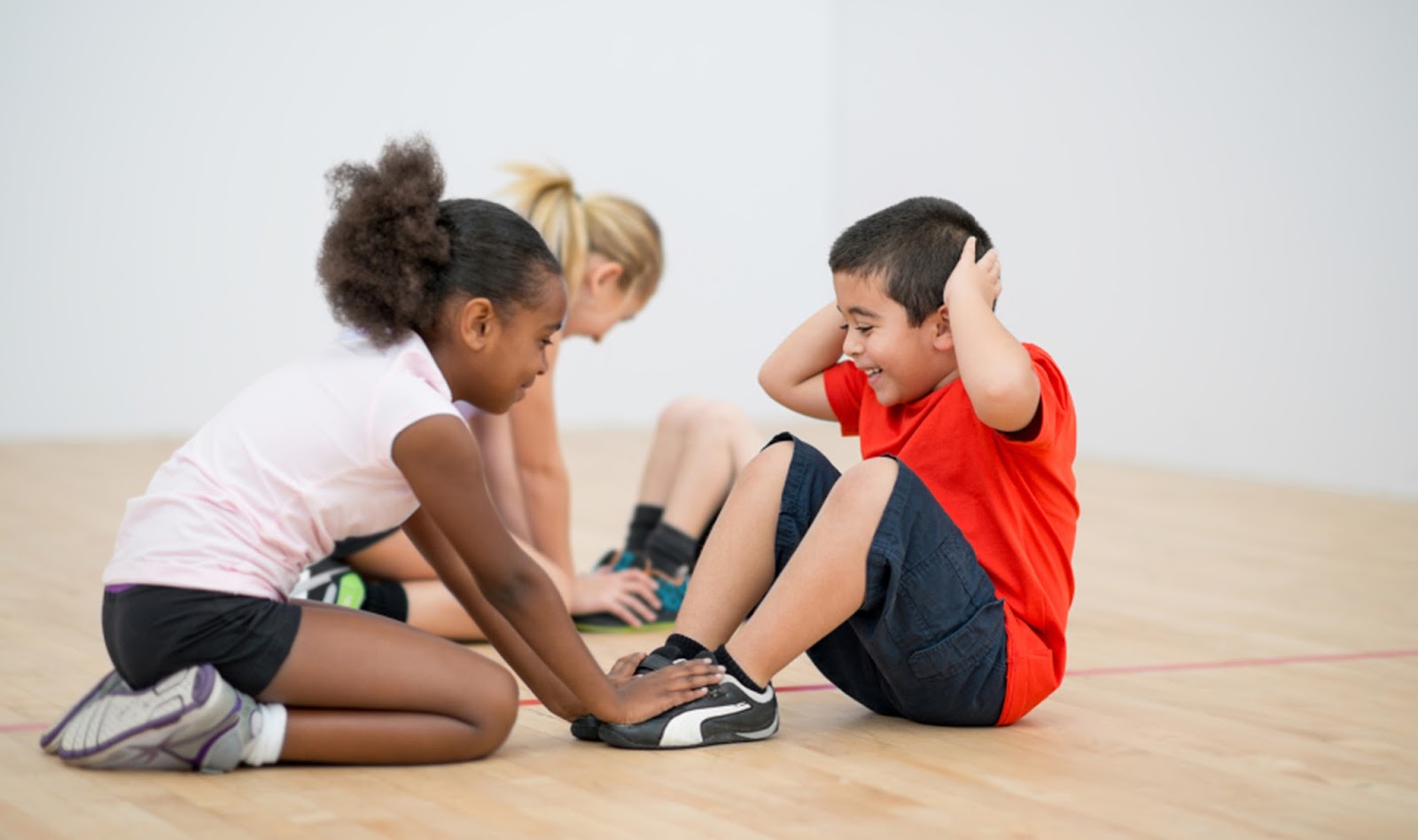 namc montessori Ideas for Non-Competitive Physical Education in the Montessori Environment children stretching in gym class