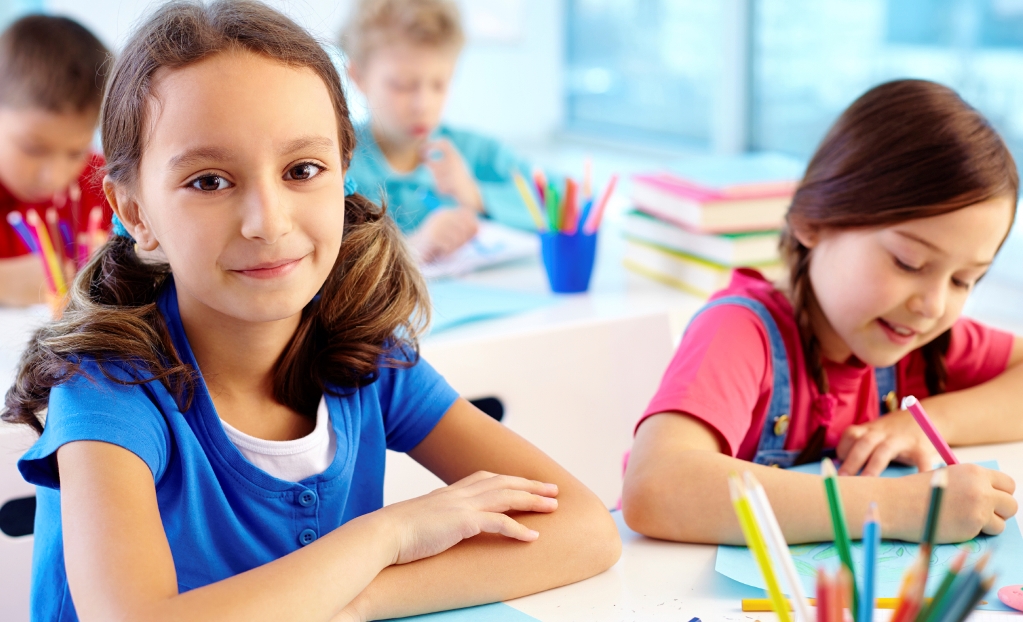 NAMC Montessori circle of inclusion: personalized instruction scientific observation and individual readiness. Girl with classmates, colouring.