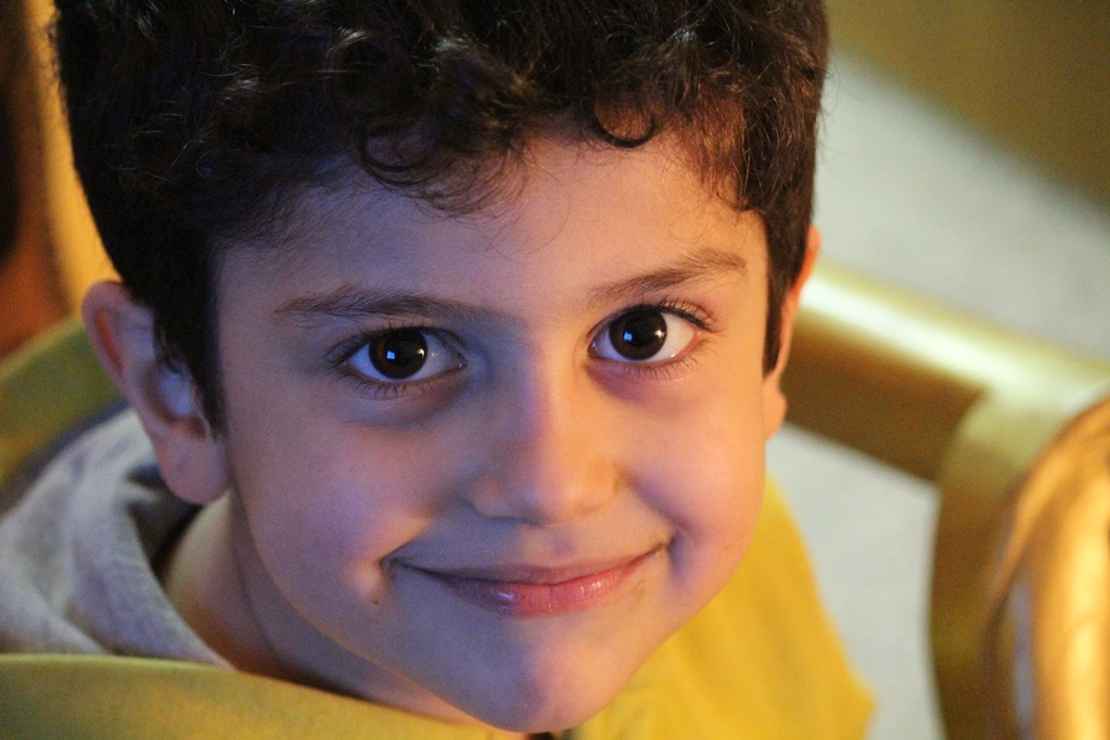 NAMC Montessori circle of inclusion: personalized instruction scientific observation and individual readiness. Headshot of young boy smiling.