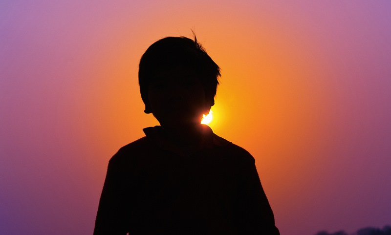 namc montessori great lessons boy silhouette in sunset