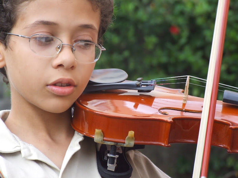 NAMC montessori environment supports children with Sensory Issues boy playing violin