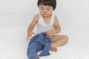 Toddler putting on pants