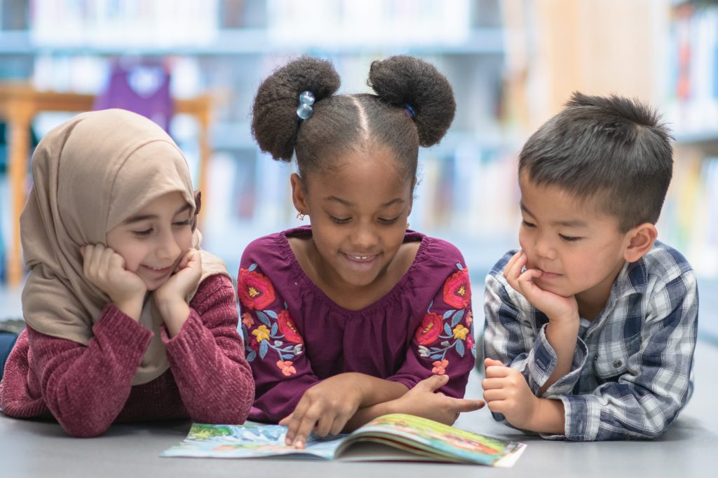 group of children reading a book together