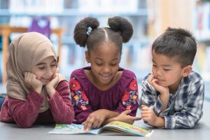 group of children reading a book together