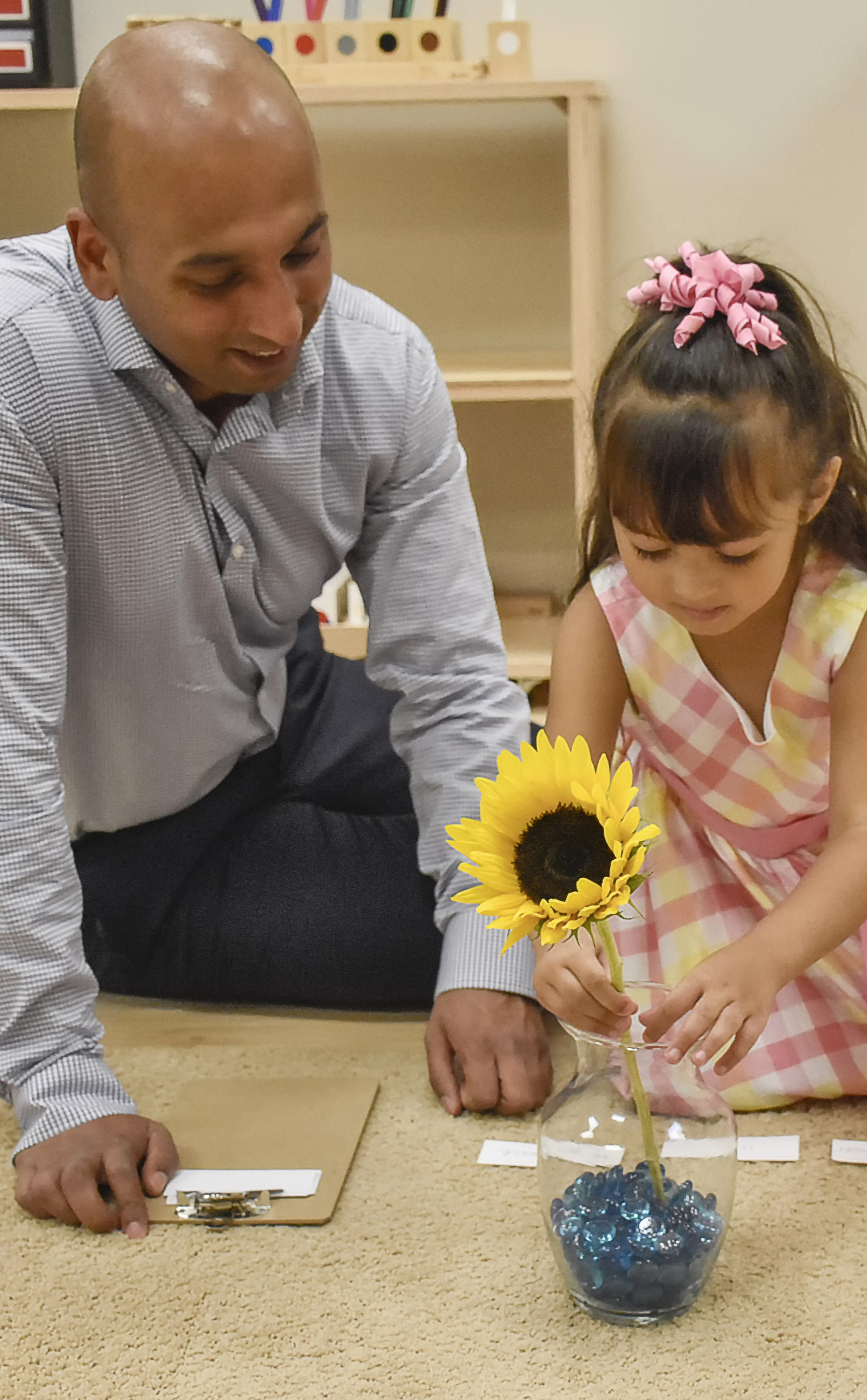 Montessori teacher and child working on grammar activity