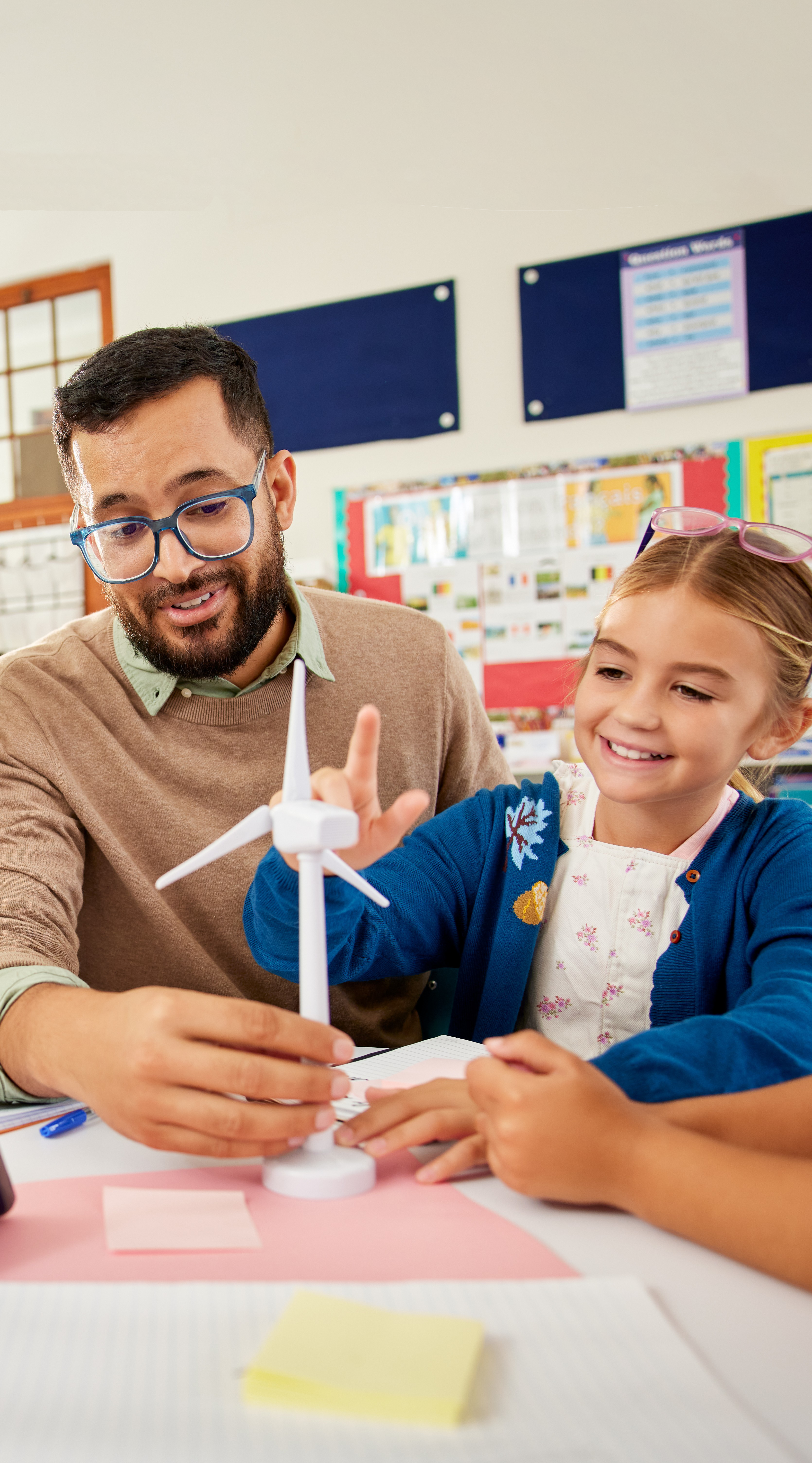 Montessori teacher and elementary student working with model turbine